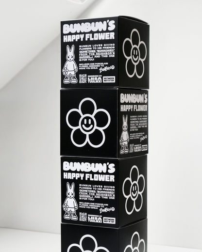BUNBUN’S HAPPY FLOWER - collectible art toy sculpture. Stack of black boxes with 'Bundun's Happy Flower' branding on a white background.